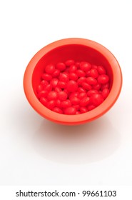 Red Hots In Bowl Isolated On White Background