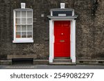 Red house door on a London street. Red residential front door