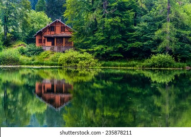 Red House In The Middle Of The Nature With View Of The Lake