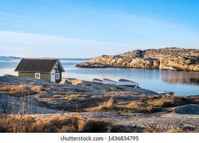 Red House At Sea Shore In The Baltic Sea. Old Small Fish House In Sweden