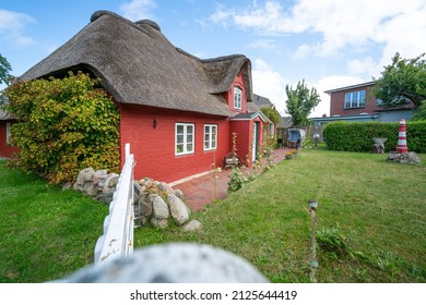 Red house with a thatched roof on the island of Amrum