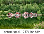 Red houses at sunset on a lake, Höga Kusten, Sweden