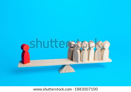 The red human figurine has equal weight against a group of people. Leader and valued employee. Highly qualified specialist. Inequality of rights. Social significance. Steadfastness and self-confidence