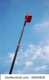 Red Hydraulic Cherry Picker Over Blue Sky