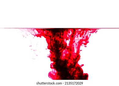 Red ink drop in water. Background,Water drop collision with abstract effect.Red ink isolated in water