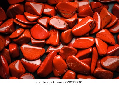 red jasper stone chips macro detail texture background. close-up polished semi-precious gemstone.
