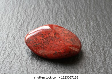 Red Jasper Stone On A Black Stone Board