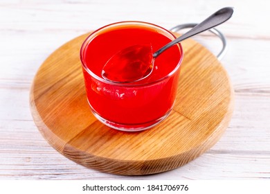 Red jelly in a glass jar. Use of natural gelatin powder, agar-agar or pectin powder