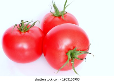 Red Juicy Raspberry Tomato On A White Background Close Up