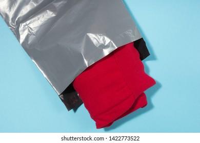 Red Jumper Packed In Gray Mailing Bag