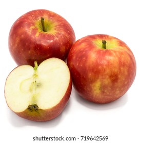 Red Kanzi apples, two whole, one half, isolated on white background