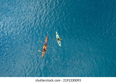 Red Kayak Boat Two Rowers On Blue Turquoise Water Sea, Sunny Day. Concept Extreme Sport, Aerial Top View.