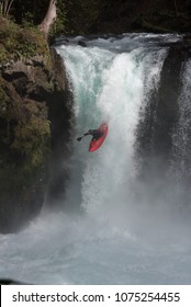 Red Kayak Going Over Waterfall