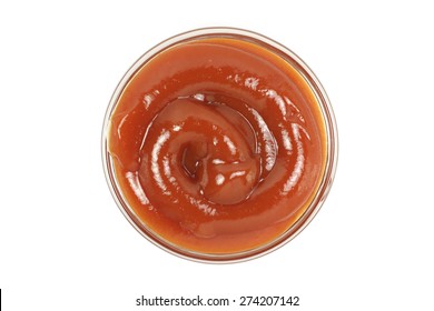 Red Ketchup In A Glass Cup On A White Background