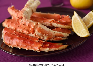 Red King Crab Legs With Lemon On A Plate