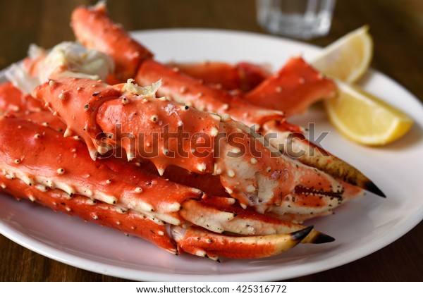 Red king crab legs\
with lemon on a plate
