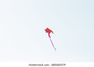 A Red Kite Flying In Clean  Sky.