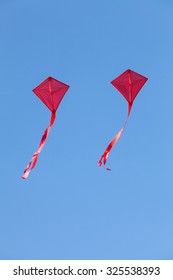 Red Kites Flying In A Beautiful Blue Sky