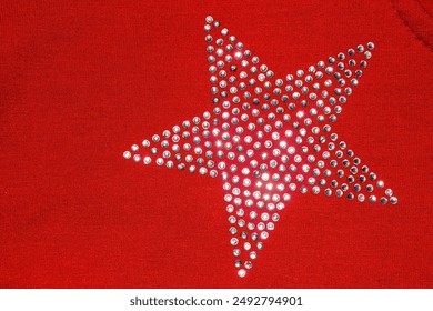 Red knitted fabric with rhinestones laid out in the shape of a star