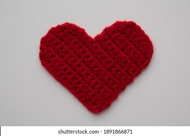 Red Knitted Heart On A White Background