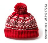 Red knitted winter bobble hat of traditional design isolated on white background