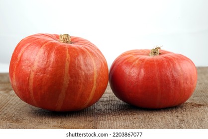 Red Kuri Squashes On A Rough Woody Texture Background. Selective Focus.