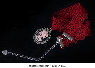 Red Lace Choker With Skeleton Girl Cameo On A Dark Background Close Up