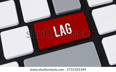 Red lag button on computer keyboard. Concept of slow internet connection, system delay and technical latency.