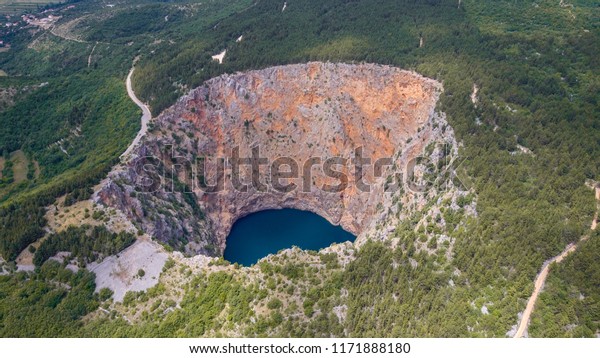 Red Lake (Croatian: Crveno jezero) is a collapse\
doline (collapse sinkhole) containing a karst lake close to\
Imotski, Croatia. It is 530 metres deep, thus it is the largest\
collapse doline in Europe.