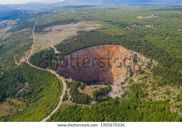 Red Lake (Croatian: Crveno jezero) is a collapse doline\
(collapse sinkhole) containing a karst lake close to Imotski,\
Croatia. It is 530 metres deep, thus it is the largest collapse\
doline in Europe. 