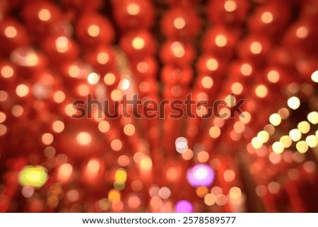 Red lanterns are the backdrop for white lights that line the lines.