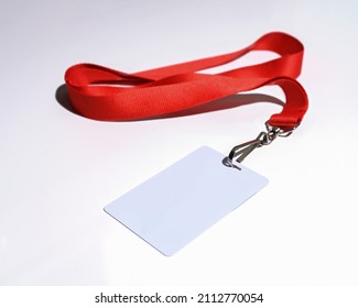 Red lanyard with blank badge isolated on white background closeup - Shutterstock ID 2112770054