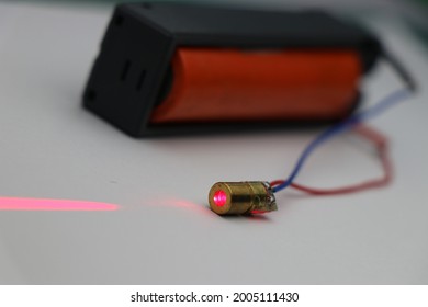 Red laser diode with copper head powered by battery emitting laser light use to make various electronic projects