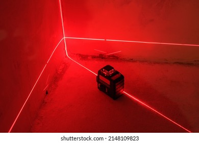 Red Laser level turned on in a dark room - Shutterstock ID 2148109823