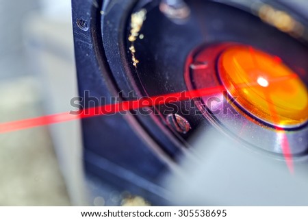 Red laser on optical table in physics laboratory