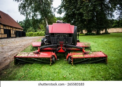 Red Lawn Mower Tractor Machine And Green Grass