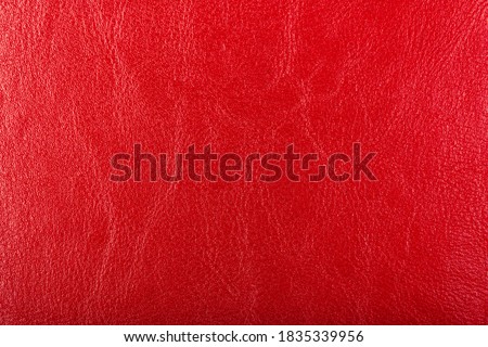 Red Leather Background. Red leather texture closeup background. Structured background design leather. A place for text or a logo. Beauty and Fashion. Red leather jacket. Lady's handbag