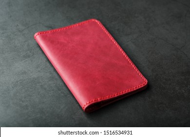 Red Leather Cover For A Passport On A Dark Background. Genuine Leather, Handmade, Close Up Stitching