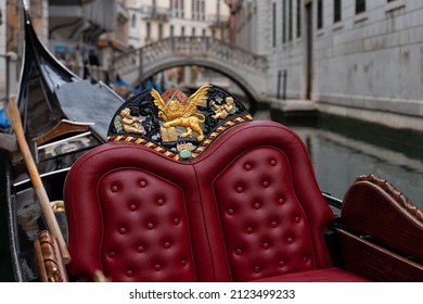 red leather seat detail of a gondola from Venice in Italy
				