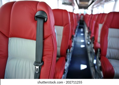 Red Leather Seats With Seat Belts In A Tourist Bus