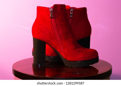 red leather shoes, pink background