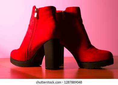 red leather shoes, pink background