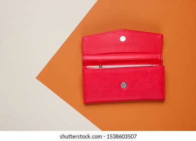 Red leather wallet on brown paper background. Color trend, minimalistic fashion still life. Top view - Powered by Shutterstock