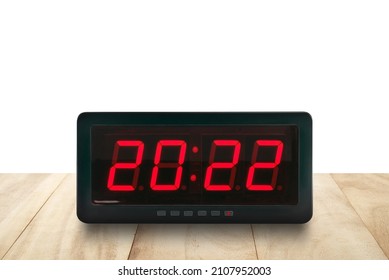 Red Led Light Illuminated Numbers 2022 On Digital Electric Alarm Clock Face On Wooden Table Top Isolated On White Background, Time Symbol For Beginning Or End Of The Year With Copy Space