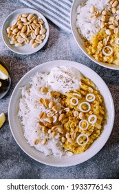 Red Lentil Dahl Dish With Peanuts And Fresh Onions Accompanied By Rice