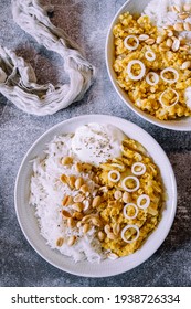 Red Lentil Dahl Dish With Peanuts And Fresh Onions Accompanied By Rice