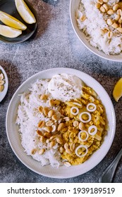 Red Lentil Dahl Dish With Peanuts And Fresh Onions Accompanied By Rice