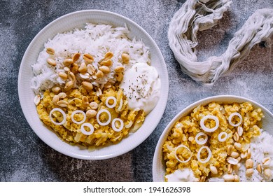 Red Lentil Dahl Dish With Peanuts And Fresh Onions Accompanied By Rice