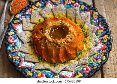 Red Lentil Hummus In Traditional Plate On The Wooden Table