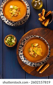 Red Lentil Soup with ingredients on colorful background. Traditional turkish or arabic lentil and vegetable spicy soup, healthy vegan food.